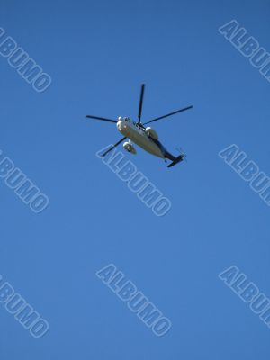 helicopter flying in the blue sky