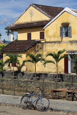 Bicycle and yellow house
