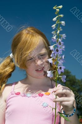 Girl with larkspur flower