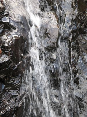water falling on a rock