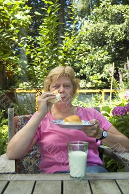 elderly woman is having lunch in the garden
