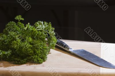 Food on a cutting board with chef`s knife