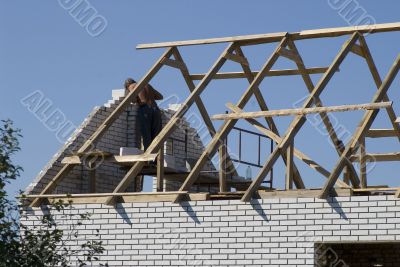 Mason building brick wall.