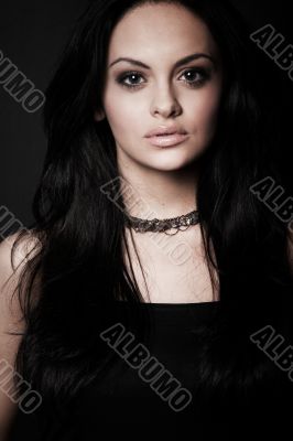 brunette girl posing on dark background