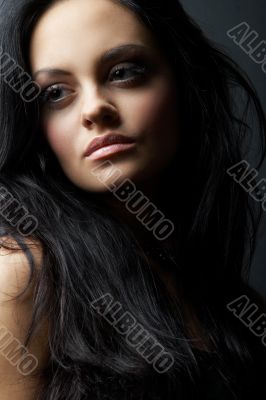 brunette girl posing on dark background