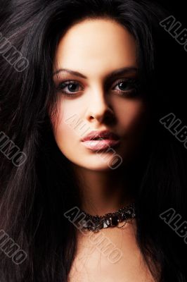 brunette girl posing on dark background