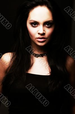 brunette girl posing on dark background