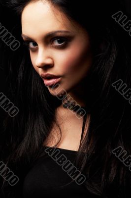 brunette girl posing on dark background
