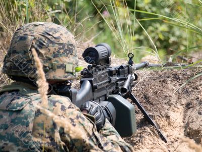 Soldier shooting his machine gun