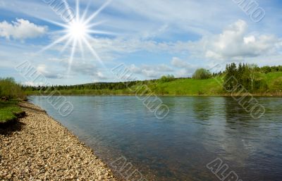 Summer landscape. Clouds above the river.