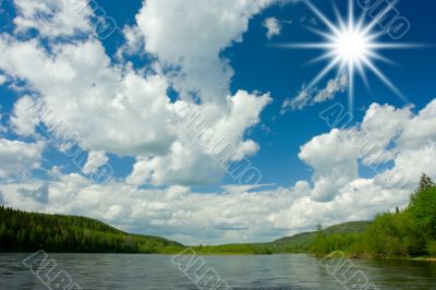 Summer landscape. Clouds above the river.