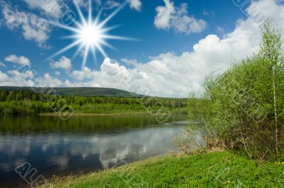Summer landscape. Clouds above the river.