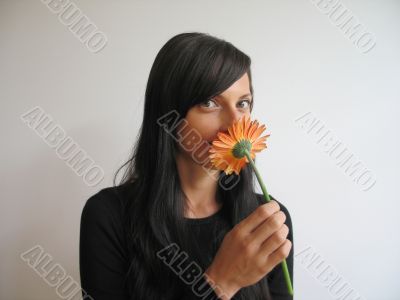 pretty girl smelling a flower