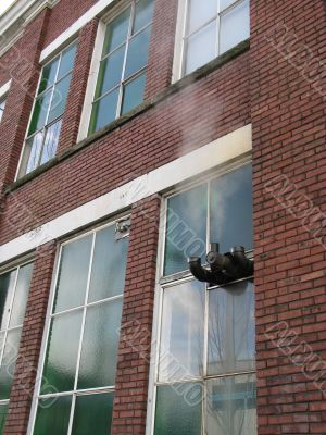 old brick building with steam pipe