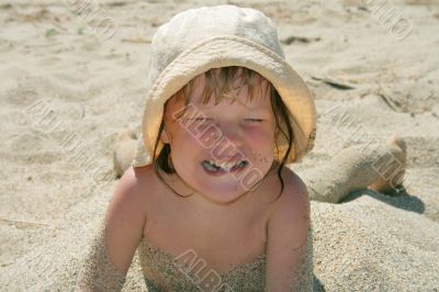 Baby girl plays with a sand