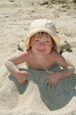 Baby girl plays with a sand