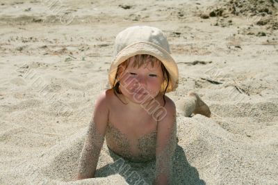 Baby girl plays with a sand