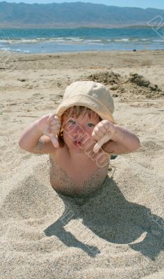 Baby girl plays with a sand
