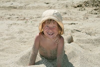 Baby girl plays with a sand