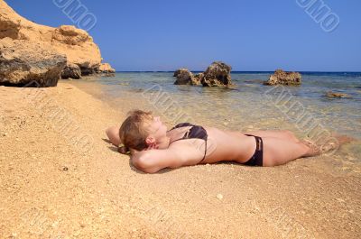 model lying on the beach