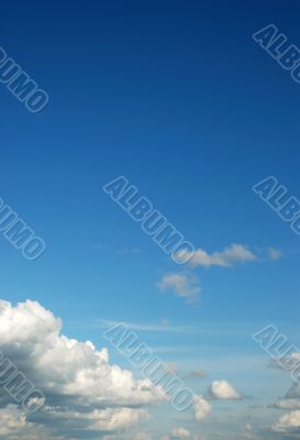 fluffy cloud on bright blue sky