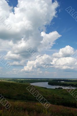 Cumulus clouds above the river