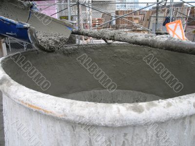 truck pouring cement into container