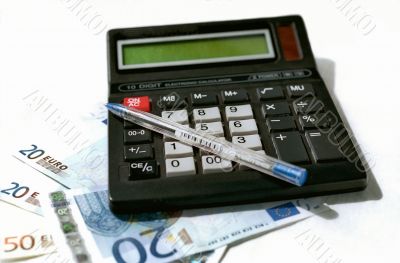 Calculator, pen and banknotes