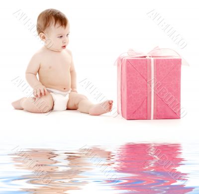 baby boy in diaper with big gift box