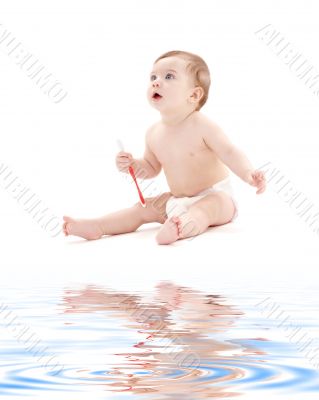baby boy in diaper with toothbrush