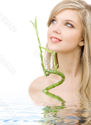 blue-eyed blonde with bamboo in water