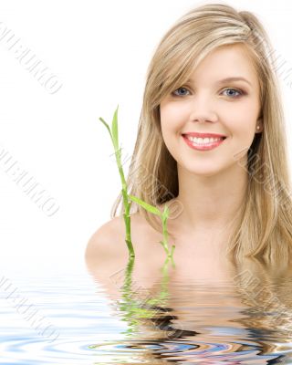 blue-eyed blonde with bamboo in water