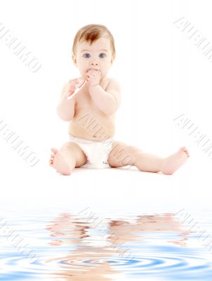 baby boy in diaper with toothbrush
