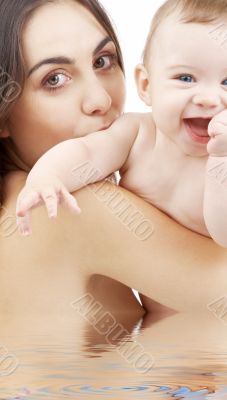 baby boy and beautiful mama in water
