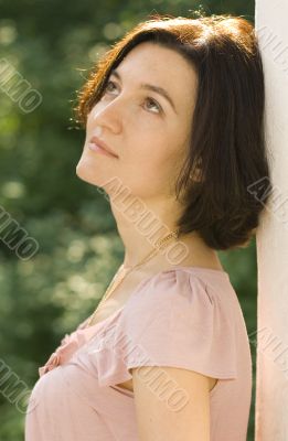 pretty woman standing near white column
