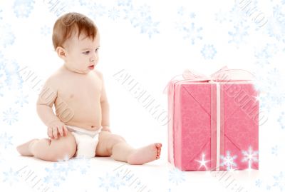 baby boy in diaper with big gift box and snowflakes