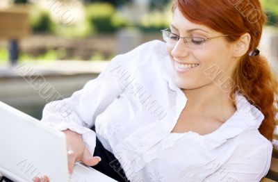 smiling businesswoman with laptop computer