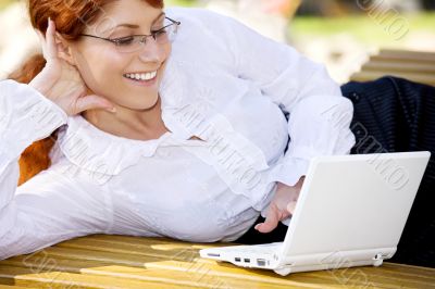 businesswoman with laptop in the park