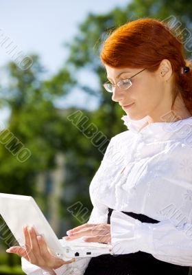 businesswoman with laptop in the park