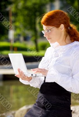businesswoman with laptop in the park