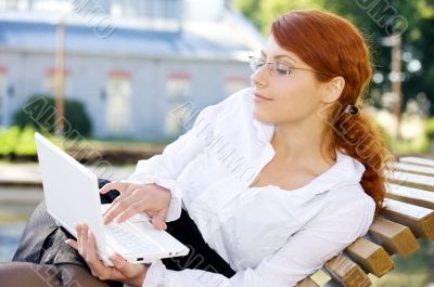 businesswoman with laptop in the park