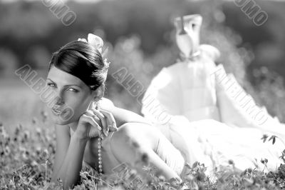 Beautiful bride lying in field
