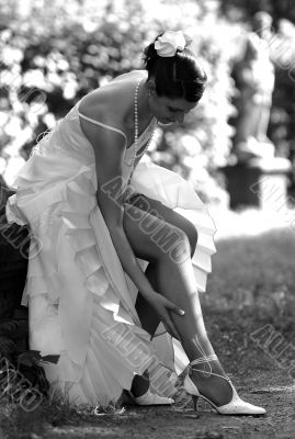 Beautiful bride adjusting her stockings