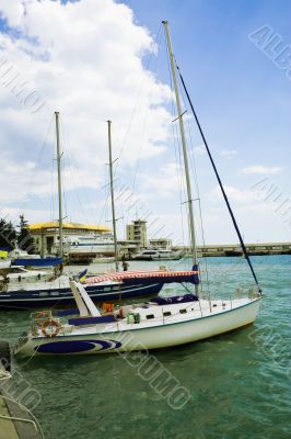 Yachts moored at the berth in the summer day