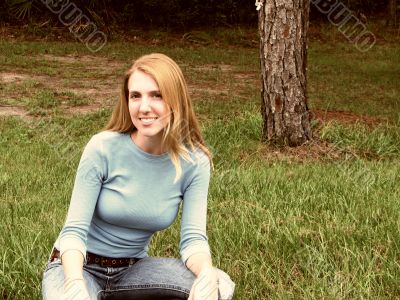 woman nealing in grass