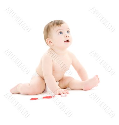 baby boy in diaper with toothbrush