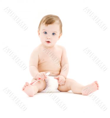 baby boy in diaper with toothbrush