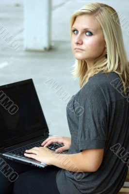 Young, blonde girl with laptop