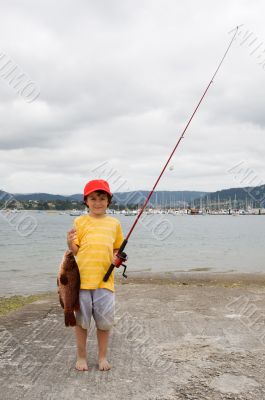 Child fisherman with red hat