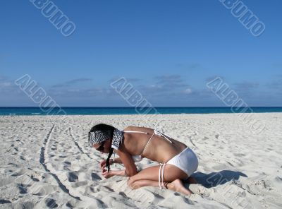 girl on the beach collecting shells